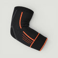 Padel Shark black knitted elbow support with orange trim and adjustable strap for tendonitis relief and mobility.