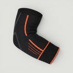 Padel Shark black knitted elbow support with orange trim and adjustable strap for tendonitis relief and mobility.