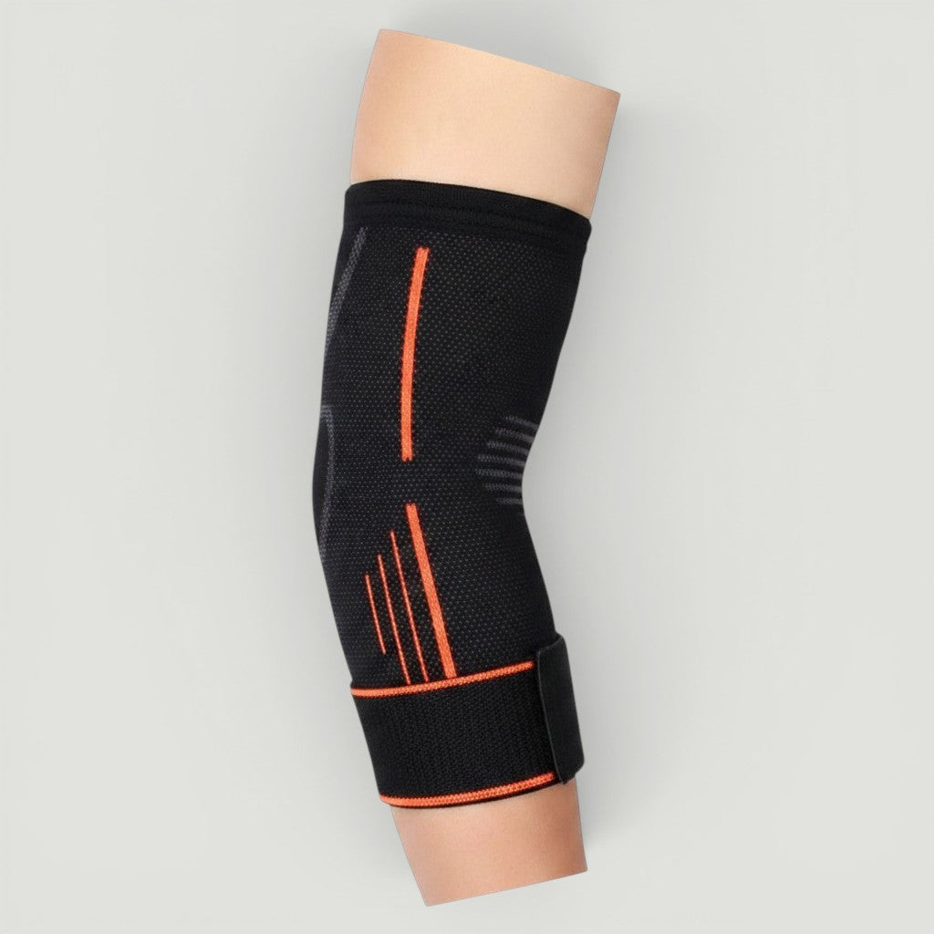 Padel Shark black knitted elbow support with orange trim and adjustable strap for tendonitis relief and mobility.