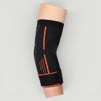 Padel Shark black knitted elbow support with orange trim and adjustable strap for tendonitis relief and mobility.